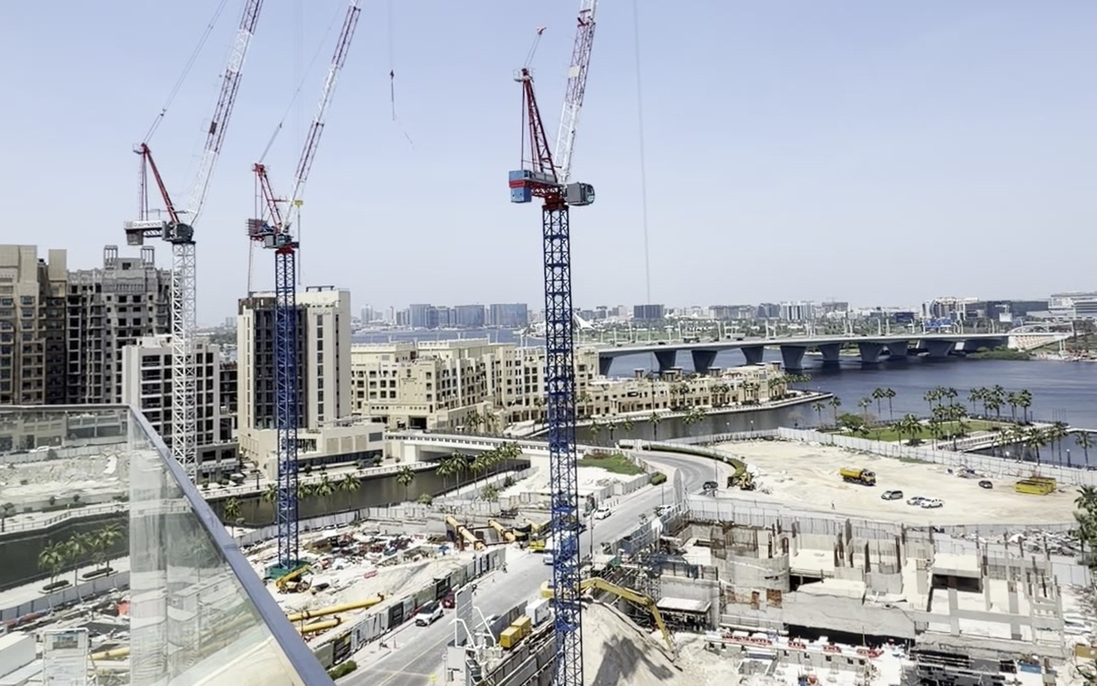 Tower cranes over an off-plan construction site on Dubai Creek, photographed by Stefano Iannotti