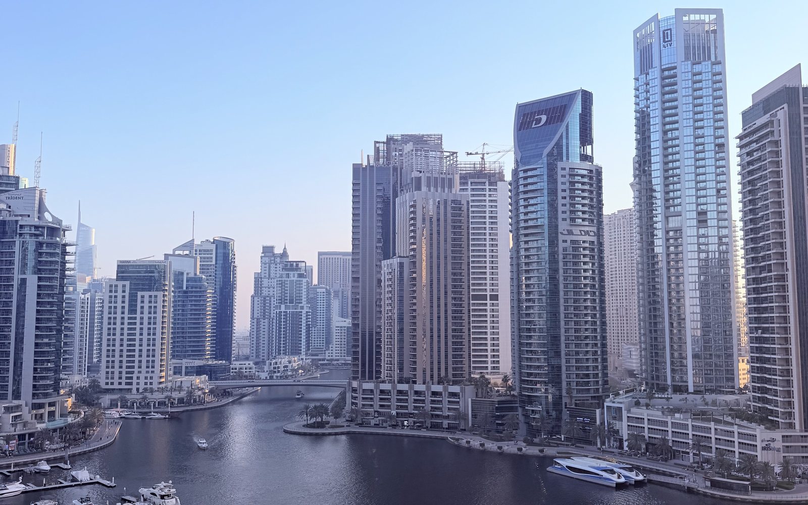 Dubai Marina canal with residential towers and moored yachts, seen from a high floor, a key area in this Dubai Marina vs JLT comparison